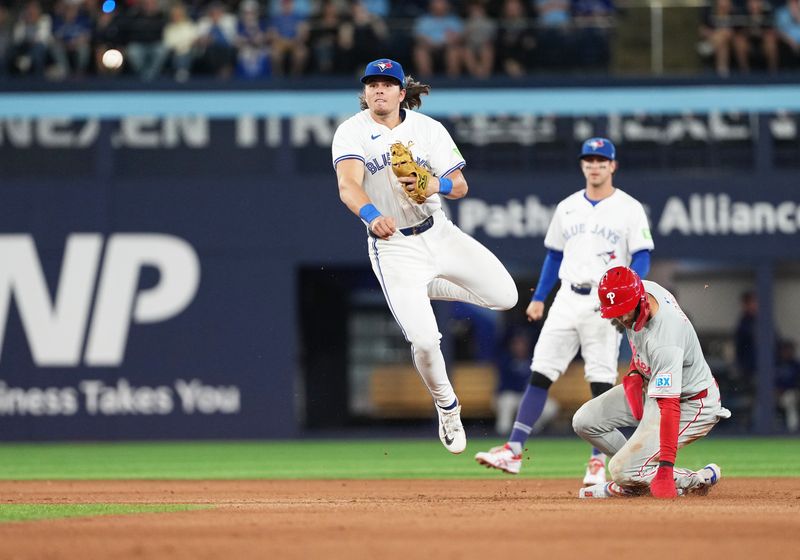 Sep 3, 2024; Toronto, Ontario, CAN; Philadelphia Phillies shortstop Trea Turner (7) is tagged out at second base by Toronto Blue Jays second baseman Addison Barger (47) during the fourth inning at Rogers Centre. Mandatory Credit: Nick Turchiaro-Imagn Images