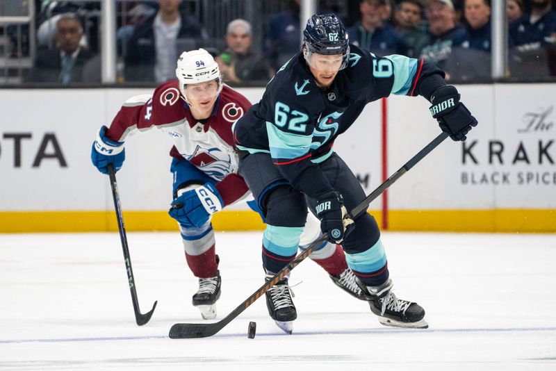 Oct 22, 2024; Seattle, Washington, USA;  Seattle Kraken defenseman Brandon Montour (62) skates against Colorado Avalanche forward Joel Kiviranta (94) during the second period at Climate Pledge Arena. Mandatory Credit: Stephen Brashear-Imagn Images