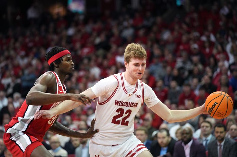 Feb 13, 2024; Madison, Wisconsin, USA;  Wisconsin Badgers forward Steven Crowl (22) dribbles the ball against Ohio State Buckeyes center Felix Okpara (34) during the second half at the Kohl Center. Mandatory Credit: Kayla Wolf-USA TODAY Sports