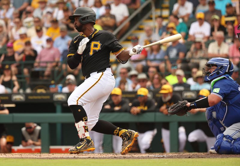 Mar 5, 2024; Bradenton, Florida, USA; Pittsburgh Pirates outfielder Andrew McCutchen (22) singles during the first inning against the Toronto Blue Jays  at LECOM Park. Mandatory Credit: Kim Klement Neitzel-USA TODAY Sports