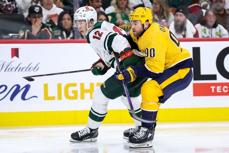 Nov 30, 2024; Saint Paul, Minnesota, USA; Minnesota Wild left wing Matt Boldy (12) and Nashville Predators center Ryan O'Reilly (90) compete for the puck during the second period at Xcel Energy Center. Mandatory Credit: Matt Krohn-Imagn Images