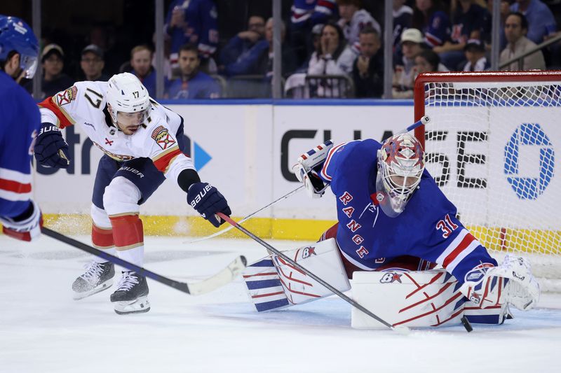 May 22, 2024; New York, New York, USA; New York Rangers goaltender Igor Shesterkin (31) covers the puck against Florida Panthers center Evan Rodrigues (17) during the second period of game one of the Eastern Conference Final of the 2024 Stanley Cup Playoffs at Madison Square Garden. Mandatory Credit: Brad Penner-USA TODAY Sports