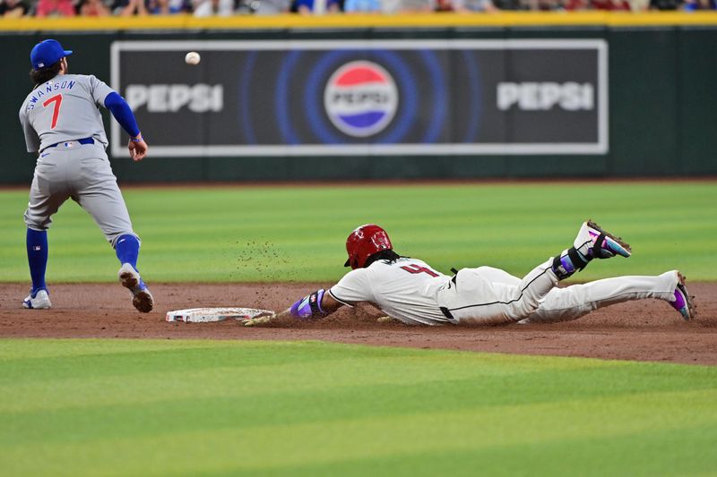 Apr 17, 2024; Phoenix, Arizona, USA;  Arizona Diamondbacks second base Ketel Marte (4) slides into second base for a double as Chicago Cubs shortstop Dansby Swanson (7) catches the ball in the third inning at Chase Field. Mandatory Credit: Matt Kartozian-USA TODAY Sports