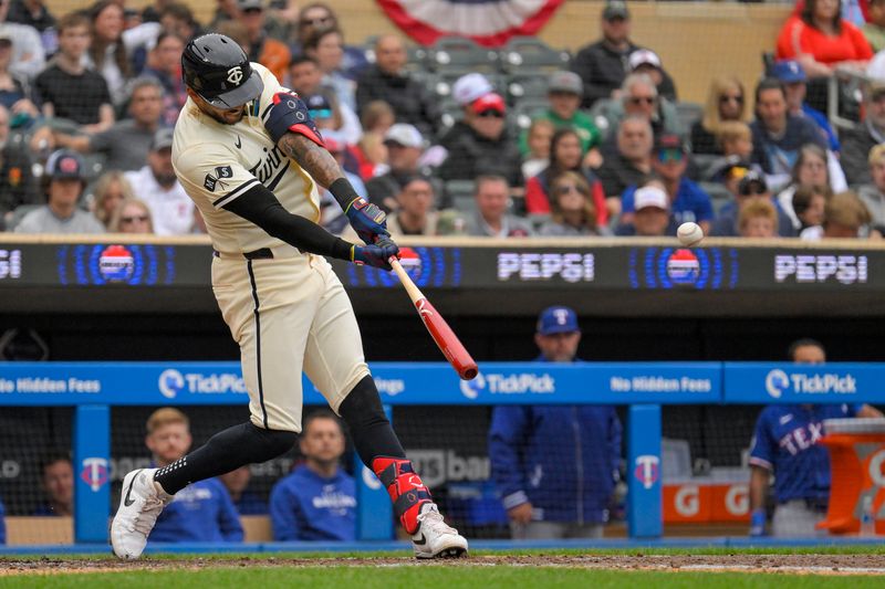 May 26, 2024; Minneapolis, Minnesota, USA;  Minnesota Twins infielder Carlos Correa (4) hits an RBI double against the Texas Rangers during the sixth inning at Target Field. Mandatory Credit: Nick Wosika-USA TODAY Sports