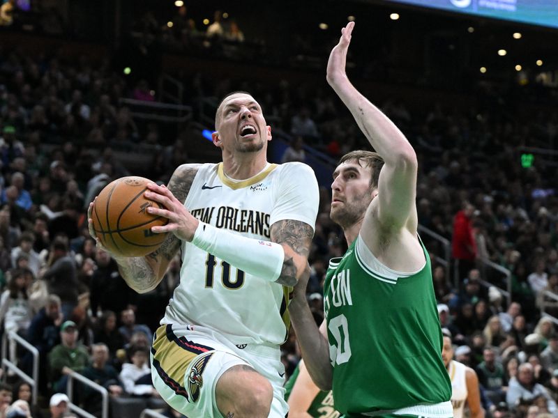 BOSTON, MASSACHUSETTS - JANUARY 12: Daniel Theis #10 of the New Orleans Pelicans drives to the basket against Luke Kornet #40 of the Boston Celtics during the third quarter at the TD Garden on January 12, 2025 in Boston, Massachusetts. NOTE TO USER: User expressly acknowledges and agrees that, by downloading and or using this photograph, User is consenting to the terms and conditions of the Getty Images License Agreement. (Photo by Brian Fluharty/Getty Images)