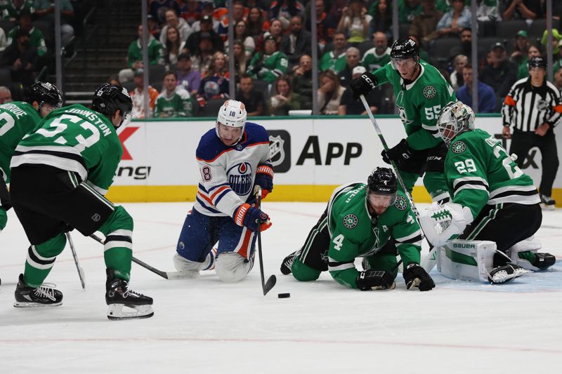 Oct 19, 2024; Dallas, Texas, USA; Edmonton Oilers left wing Zach Hyman (18) battles for the puck against Dallas Stars center Mavrik Bourque (22) and defenseman Miro Heiskanen (4) and goaltender Jake Oettinger (29) in the first period at American Airlines Center. Mandatory Credit: Tim Heitman-Imagn Images