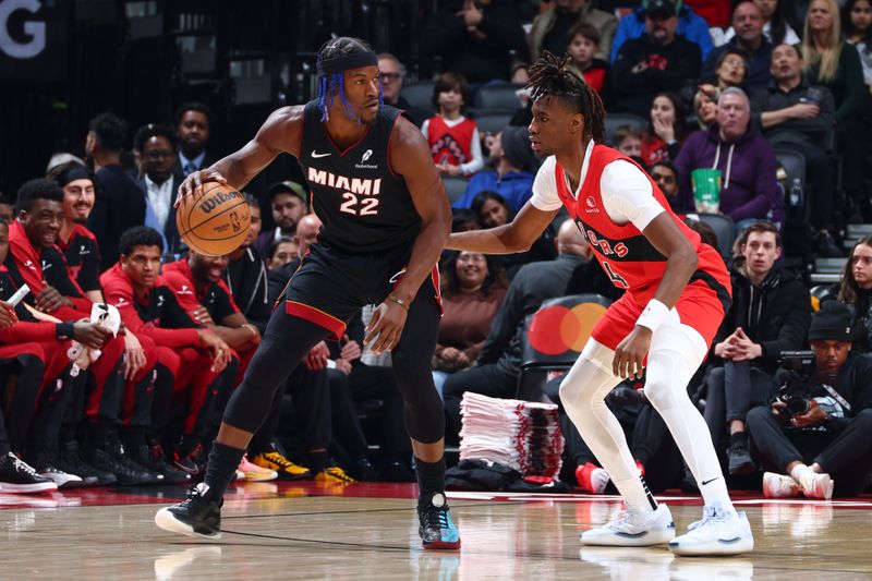 TORONTO, CANADA - DECEMBER 01:  Jimmy Butler #22 of the Miami Heat dribbles the ball during the game against the Toronto Raptors on December 1, 2024 at the Scotiabank Arena in Toronto, Ontario, Canada.  NOTE TO USER: User expressly acknowledges and agrees that, by downloading and or using this Photograph, user is consenting to the terms and conditions of the Getty Images License Agreement.  Mandatory Copyright Notice: Copyright 2024 NBAE (Photo by Vaughn Ridley/NBAE via Getty Images)