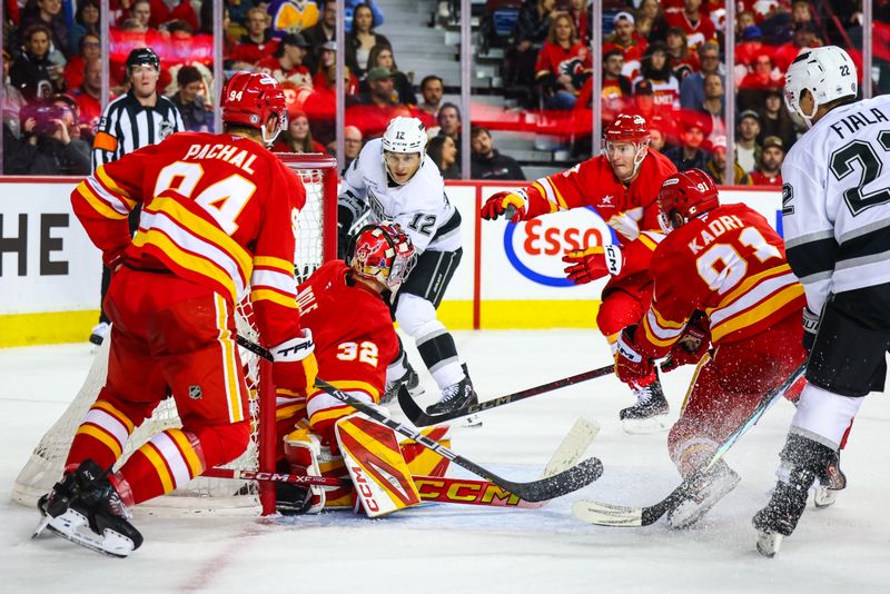 Nov 11, 2024; Calgary, Alberta, CAN; Los Angeles Kings left wing Trevor Moore (12) scores a goal against Calgary Flames goaltender Dustin Wolf (32) during the third period at Scotiabank Saddledome. Mandatory Credit: Sergei Belski-Imagn Images