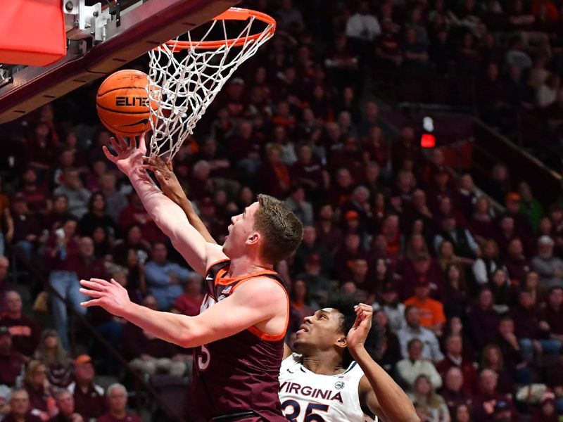 Feb 19, 2024; Blacksburg, Virginia, USA; Virginia Tech Hokies guard Sean Pedulla (3) goes in for a layup while being defended by Virginia Cavaliers guard Leon Bond III (35) during the second half at Cassell Coliseum. Mandatory Credit: Brian Bishop-USA TODAY Sports