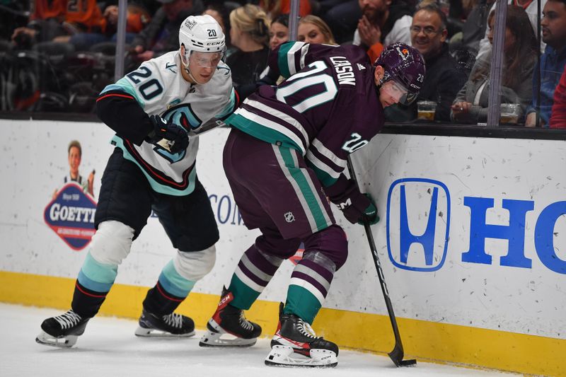 Dec 23, 2023; Anaheim, California, USA; Seattle Kraken right wing Eeli Tolvanen (20) plays for the puck against Anaheim Ducks right wing Brett Leason (20) during the second period at Honda Center. Mandatory Credit: Gary A. Vasquez-USA TODAY Sports