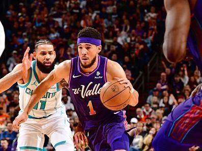 PHOENIX, AZ - DECEMBER 29: Devin Booker #1 of the Phoenix Suns dribbles the ball during the game against the Charlotte Hornets on December 29 2023 at Footprint Center in Phoenix, Arizona. NOTE TO USER: User expressly acknowledges and agrees that, by downloading and or using this photograph, user is consenting to the terms and conditions of the Getty Images License Agreement. Mandatory Copyright Notice: Copyright 2023 NBAE (Photo by Barry Gossage/NBAE via Getty Images)