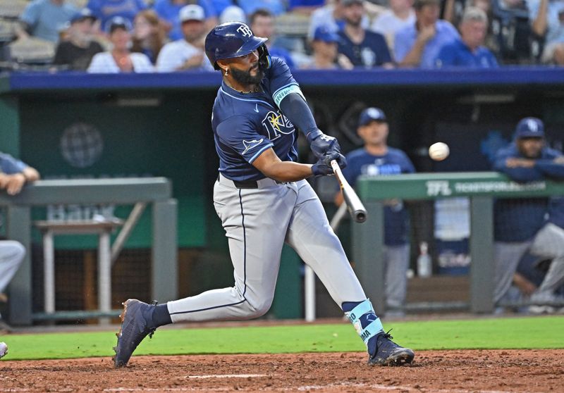 Jun 24, 2025; Kansas City, Missouri, USA;  Tampa Bay Rays right fielder Junior Caminero (13) doubles in the eighth inning against the Kansas City Royals at Kauffman Stadium. Mandatory Credit: Peter Aiken-Imagn Images