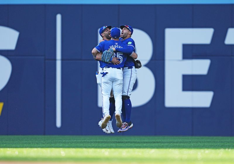 May 20, 2024; Toronto, Ontario, CAN; Toronto Blue Jays left fielder Daulton Varsho (25) and center fielder Kevin Kiermaier (39) and right fielder George Springer (4) celebrate the win against the Chicago White Sox at the end of the ninth inning at Rogers Centre. Mandatory Credit: Nick Turchiaro-USA TODAY Sports