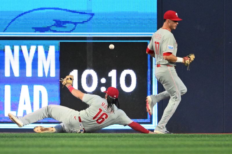 Jun 4, 2025; Toronto, Ontario, CAN;  Philadelphia Phillies center fielder Brandon Marsh (16) and left fielder Max Kepler (17) cannot reach a ball hit for a double by Toronto Blue Jays shortstop Bo Bichette (not shown) in the sixth inning at Rogers Centre. Mandatory Credit: Dan Hamilton-Imagn Images