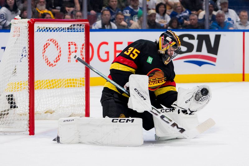 Jan 20, 2024; Vancouver, British Columbia, CAN; Vancouver Canucks goalie Thatcher Demko (35) makes a save against the Toronto Maple Leafs in the second period at Rogers Arena. Mandatory Credit: Bob Frid-USA TODAY Sports