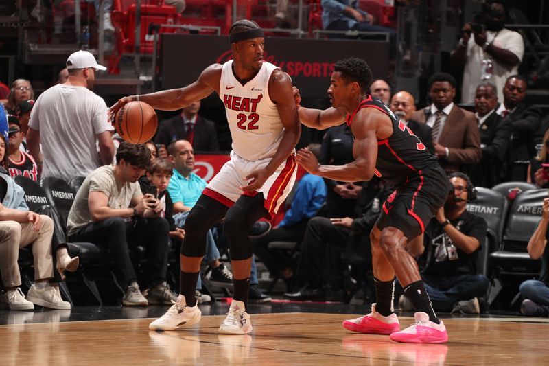 MIAMI, FL - APRIL 14:  Ochai Agbaji #30 of the Toronto Raptors plays defense during the game  against Jimmy Butler #22 of the Miami Heat on April 14, 2024 at Kaseya Center in Miami, Florida. NOTE TO USER: User expressly acknowledges and agrees that, by downloading and or using this Photograph, user is consenting to the terms and conditions of the Getty Images License Agreement. Mandatory Copyright Notice: Copyright 2024 NBAE (Photo by Issac Baldizon/NBAE via Getty Images)