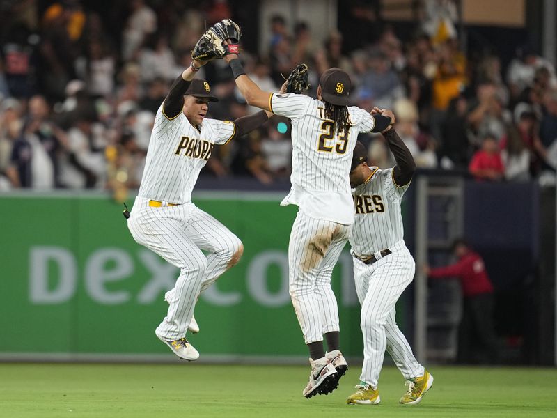 Aug 16, 2023; San Diego, California, USA;  Diego Padres left fielder Juan Soto (left) celebrates with right fielder Fernando Tatis Jr. (23) and center fielder Trent Grisham (right) after the game against the Baltimore Orioles at Petco Park. Mandatory Credit: Ray Acevedo-USA TODAY Sports