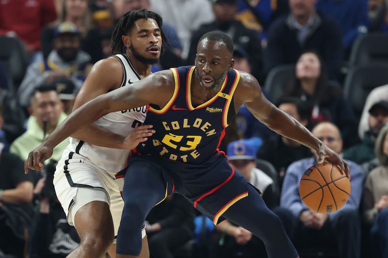 SAN FRANCISCO, CALIFORNIA - NOVEMBER 25: Draymond Green #23 of the Golden State Warriors is guarded by Cam Thomas #24 of the Brooklyn Nets in the first half at Chase Center on November 25, 2024 in San Francisco, California. NOTE TO USER: User expressly acknowledges and agrees that, by downloading and/or using this photograph, user is consenting to the terms and conditions of the Getty Images License Agreement.   (Photo by Ezra Shaw/Getty Images)