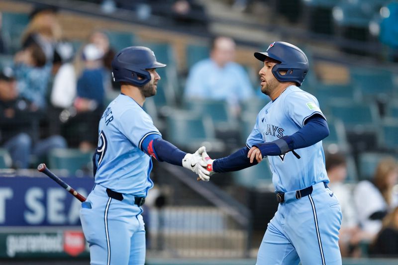 May 27, 2024; Chicago, Illinois, USA; Toronto Blue Jays outfielder George Springer (4) celebrates with outfielder Kevin Kiermaier (39) after scoring against the Chicago White Sox during the fourth inning at Guaranteed Rate Field. Mandatory Credit: Kamil Krzaczynski-USA TODAY Sports