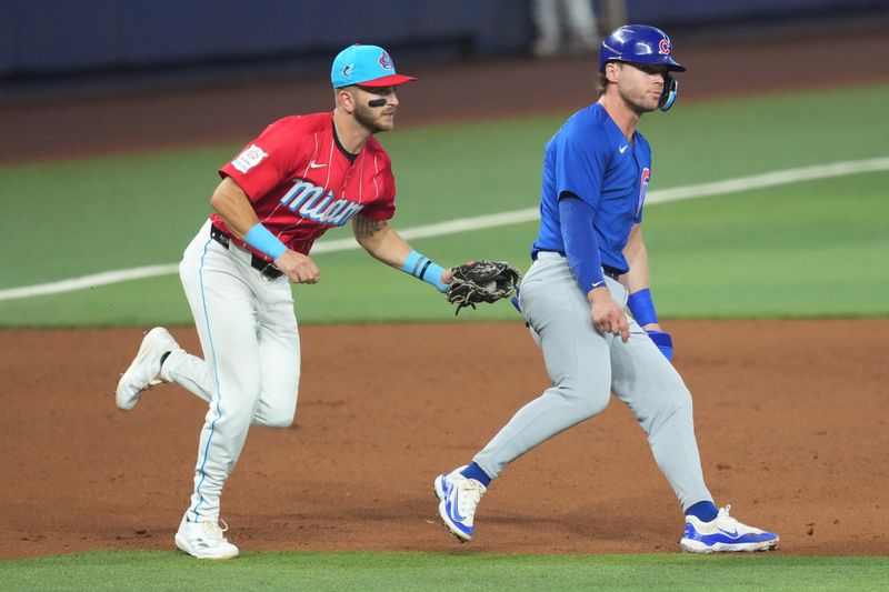 Aug 24, 2024; Miami, Florida, USA;  Miami Marlins third baseman Connor Norby (24) tags out Chicago Cubs second baseman Nico Hoerner (2) during a rundown in the fifth inning at loanDepot Park. Mandatory Credit: Jim Rassol-USA TODAY Sports