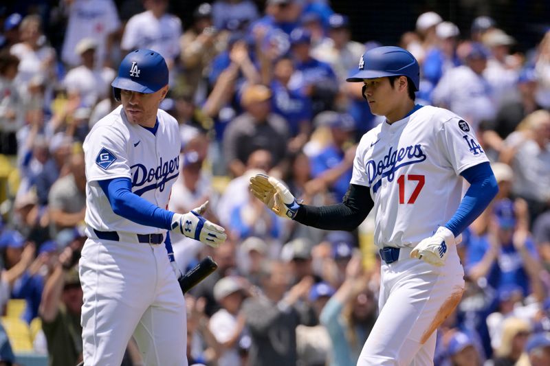 Apr 30, 2025; Los Angeles, California, USA; Los Angeles Dodgers designated hitter Shohei Ohtani (17) is greeted by first base Freddie Freeman (5) after scoring against the Miami Marlins during the third inning at Dodger Stadium. Mandatory Credit: Jayne Kamin-Oncea-Imagn Images
