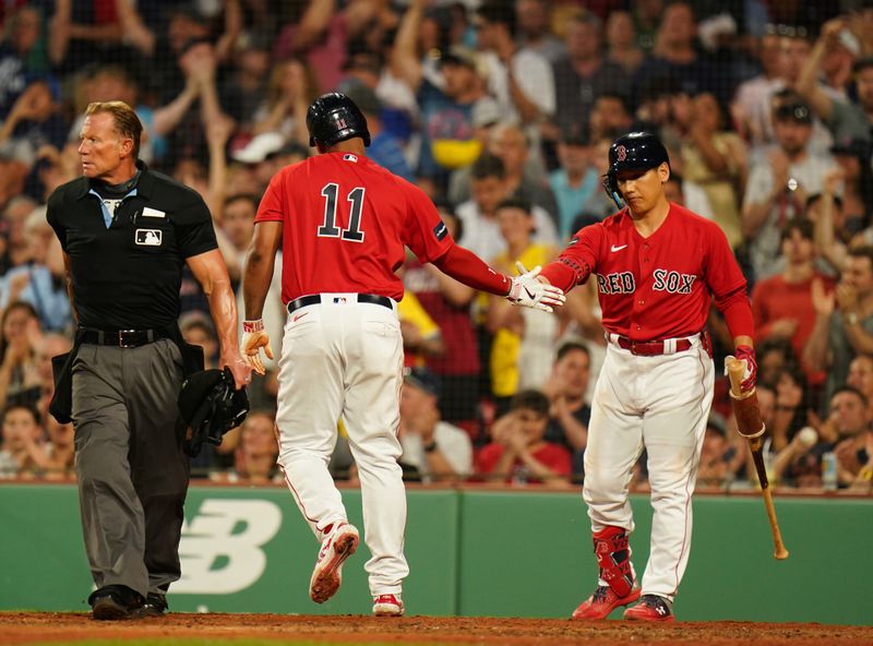 Jun 1, 2023; Boston, Massachusetts, USA; Boston Red Sox third baseman Rafael Devers (11) is congratulated by left fielder Masataka Yoshida (7) after scoring against the Cincinnati Reds in the fourth inning at Fenway Park. Mandatory Credit: David Butler II-USA TODAY Sports