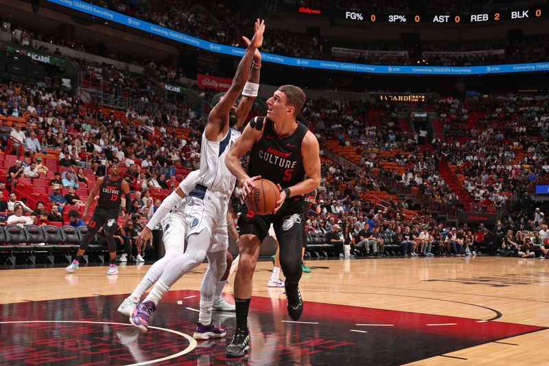 MIAMI, FL - APRIL 10: Nikola Jovic #5 of the Miami Heat drives to the basket during the game against the Dallas Mavericks on April 10, 2024 at Kaseya Center in Miami, Florida. NOTE TO USER: User expressly acknowledges and agrees that, by downloading and or using this Photograph, user is consenting to the terms and conditions of the Getty Images License Agreement. Mandatory Copyright Notice: Copyright 2024 NBAE (Photo by Issac Baldizon/NBAE via Getty Images)