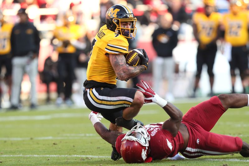 Nov 24, 2023; Fayetteville, Arkansas, USA; Missouri Tigers running back Cody Schrader (70) rushes during the first quarter against the Arkansas Razorbacks at Donald W. Reynolds Razorback Stadium. Mandatory Credit: Nelson Chenault-USA TODAY Sports