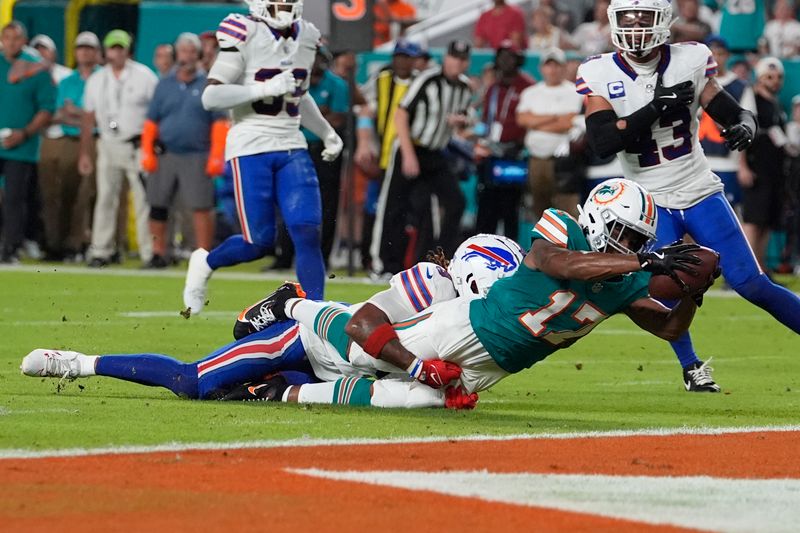 Buffalo Bills safety Damar Hamlin grabs Miami Dolphins wide receiver Jaylen Waddle (17) short of the end zone during the first half of an NFL football game, Thursday, Sept. 12, 2024, in Miami Gardens, Fla (AP Photo/Lynne Sladky)