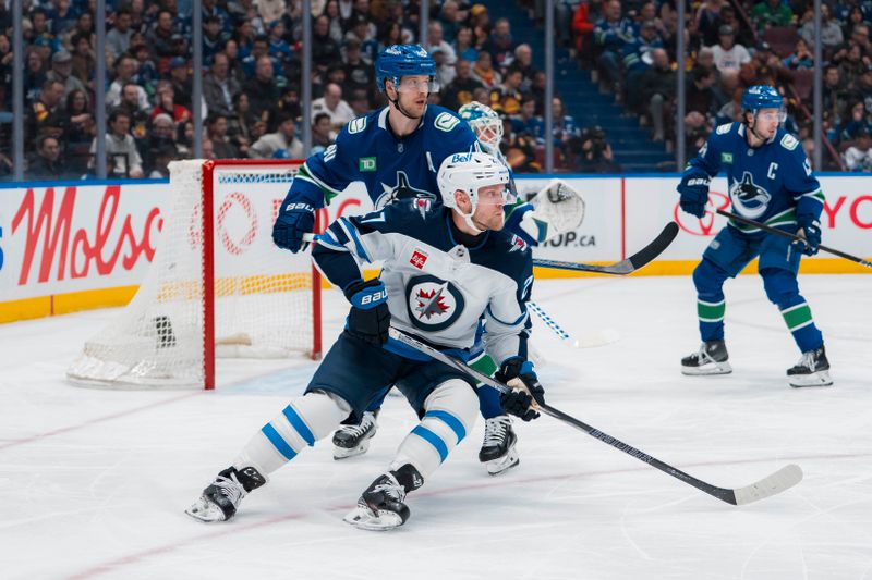 Mar 18, 2025; Vancouver, British Columbia, CAN; Vancouver Canucks forward Elias Pettersson (40) battles with Winnipeg Jets forward Nikolaj Ehlers (27) in the first period at Rogers Arena. Mandatory Credit: Bob Frid-Imagn Images