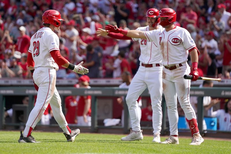 Jun 25, 2023; Cincinnati, Ohio, USA; Cincinnati Reds center fielder TJ Friedl (29) is congratulated by shortstop Kevin Newman (28) and first baseman Spencer Steer (7) after scoring in the eighth inning of a baseball game against the Atlanta Braves at Great American Ball Park. The Atlanta Braves won, 7-6. Mandatory Credit: Kareem Elgazzar-USA TODAY Sports