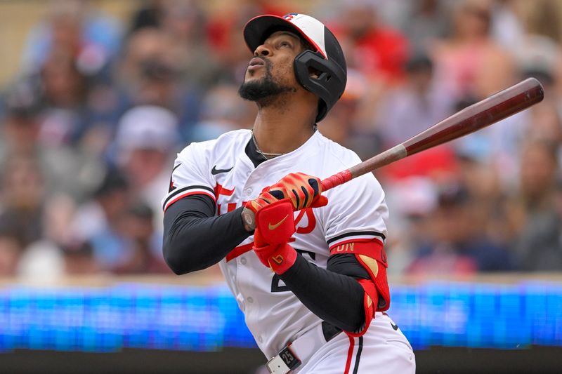 May 25, 2024; Minneapolis, Minnesota, USA;  Minnesota Twins outfielder Byron Buxton (25) watches the high chopper he just hit land for an infield single against the Texas Rangers during the first inning at Target Field. Mandatory Credit: Nick Wosika-USA TODAY Sports