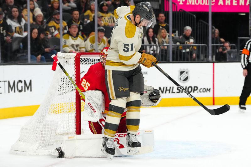 Jan 13, 2024; Las Vegas, Nevada, USA; Calgary Flames goaltender Jacob Markstrom (25) makes a save as Vegas Golden Knights center Byron Froese (51) attempts a deflection during the second period at T-Mobile Arena. Mandatory Credit: Stephen R. Sylvanie-USA TODAY Sports