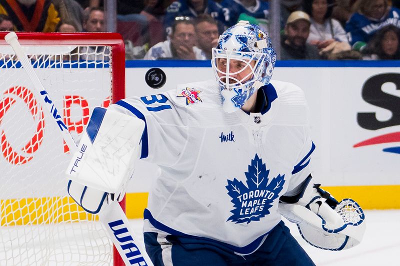 Jan 20, 2024; Vancouver, British Columbia, CAN; Toronto Maple Leafs goalie Martin Jones (31) watches the shot from Vancouver Canucks forward Elias Pettersson (40) rebound off the post in the third period at Rogers Arena. Canucks won 6-4. Mandatory Credit: Bob Frid-USA TODAY Sports