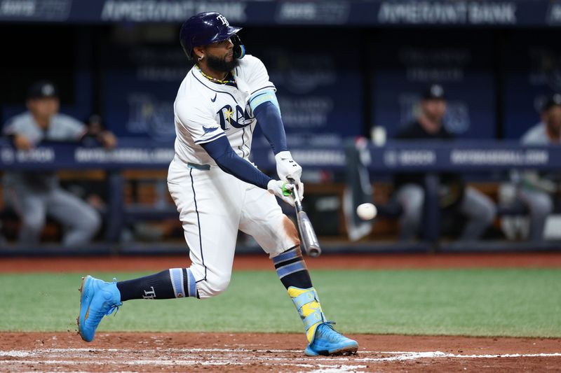 Sep 2, 2024; St. Petersburg, Florida, USA; Tampa Bay Rays third baseman Junior Caminero (13) hits an rbi double against the Minnesota Twins in the second inning at Tropicana Field. Mandatory Credit: Nathan Ray Seebeck-USA TODAY Sports