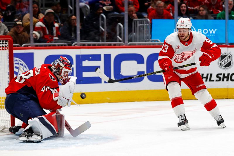 Mar 18, 2025; Washington, District of Columbia, USA; Detroit Red Wings right wing Alex DeBrincat (93) shoots the puck against Washington Capitals goaltender Logan Thompson (48) during the second period at Capital One Arena. Mandatory Credit: Peter Casey-Imagn Images