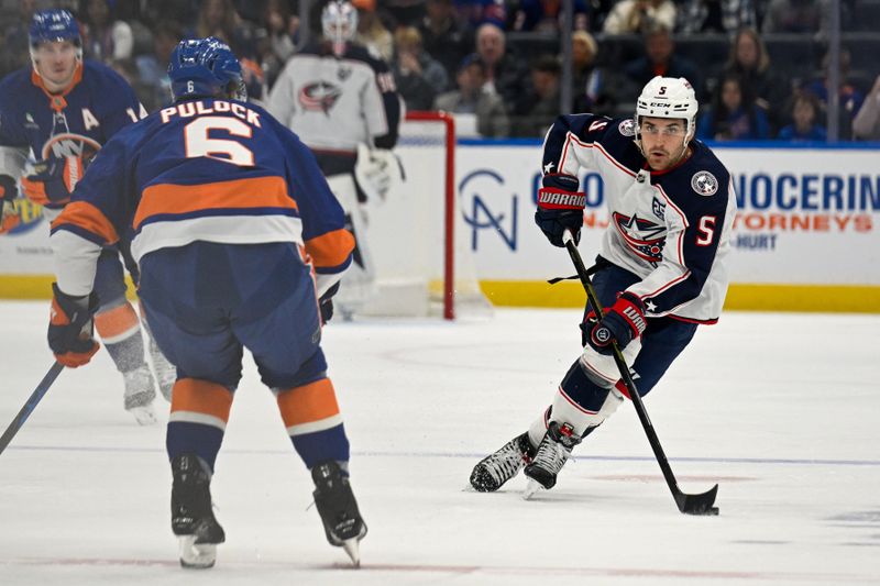 Nov 2, 2025; Elmont, New York, USA;  Columbus Blue Jackets defenseman Denton Mateychuk (5) skates with the puck against the New York Islanders during the first period at UBS Arena. Mandatory Credit: Dennis Schneidler-Imagn Images