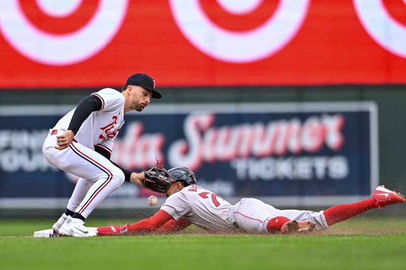 May 4, 2024; Minneapolis, Minnesota, USA; Minnesota Twins second base Edouard Julien (47) drops the ball as Boston Red Sox shortstop David Hamilton (70) slides in for a stolen base during the fifth inning at Target Field. Mandatory Credit: Jeffrey Becker-USA TODAY Sports