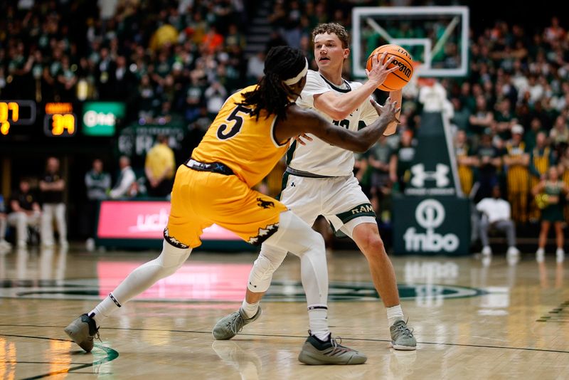 Feb 15, 2025; Fort Collins, Colorado, USA; Colorado State Rams guard Bowen Born (13) controls the ball as Colorado State Rams forward Jon Mekonnen (5) guards in the second half at Moby Arena. Mandatory Credit: Isaiah J. Downing-Imagn Images