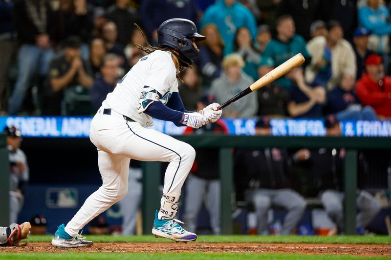 Apr 2, 2024; Seattle, Washington, USA; Seattle Mariners shortstop J.P. Crawford (3) hits an RBI-fielders choice against the Cleveland Guardians during the seventh inning at T-Mobile Park. Mandatory Credit: Joe Nicholson-USA TODAY Sports