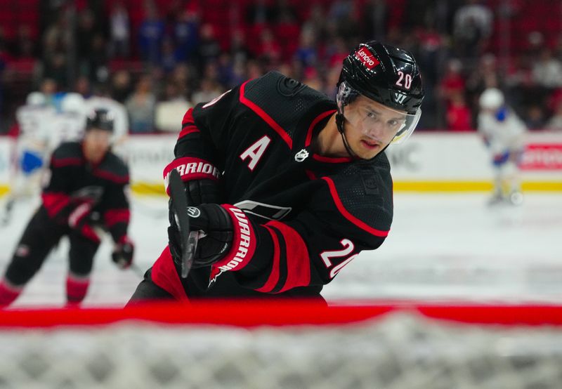 Dec 2, 2023; Raleigh, North Carolina, USA; Carolina Hurricanes center Sebastian Aho (20) takes a shot during the warmups against the Buffalo Sabres at PNC Arena. Mandatory Credit: James Guillory-USA TODAY Sports