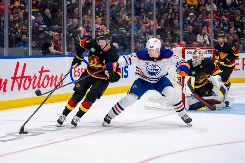 Nov 9, 2024; Vancouver, British Columbia, CAN; Edmonton Oilers forward Vasily Podkolzin (92) stick checks Vancouver Canucks forward Elias Pettersson (40) during the third period at Rogers Arena. Mandatory Credit: Bob Frid-Imagn Images