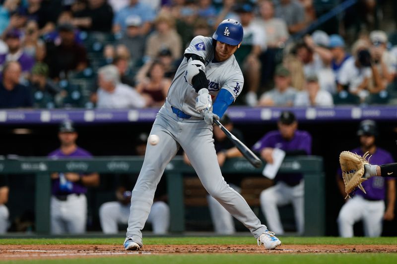 Sep 27, 2024; Denver, Colorado, USA; Los Angeles Dodgers designated hitter Shohei Ohtani (17) hits an RBI single in the second inning against the Colorado Rockies at Coors Field. Mandatory Credit: Isaiah J. Downing-Imagn Images