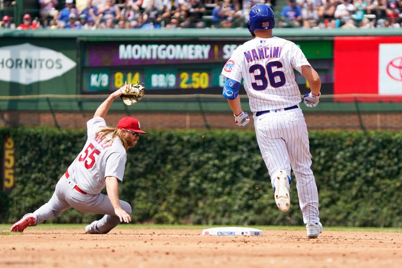 Jul 23, 2023; Chicago, Illinois, USA; Chicago Cubs first baseman Trey Mancini (36) runs to second base with a double as St. Louis Cardinals second baseman Tyler Motter (55) makes a late tag during the third inning at Wrigley Field. Mandatory Credit: David Banks-USA TODAY Sports