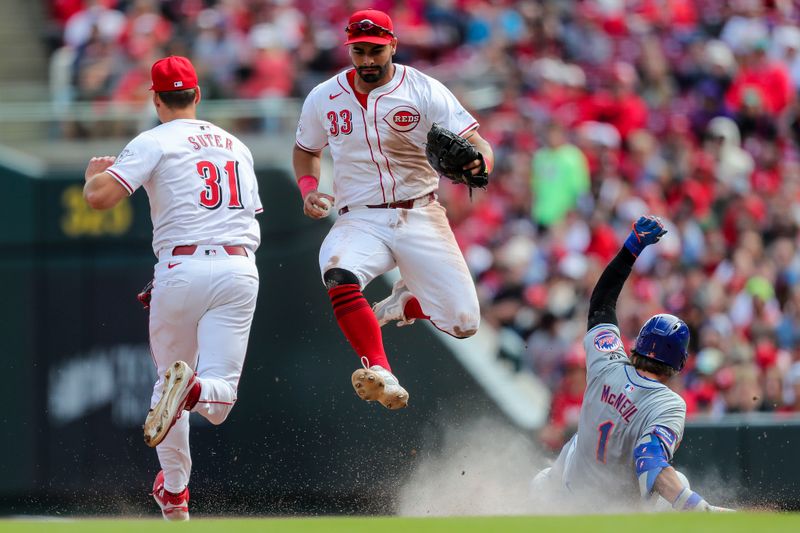 Apr 7, 2024; Cincinnati, Ohio, USA; Cincinnati Reds first baseman Christian Encarnacion-Strand (33) tags first base to get New York Mets second baseman Jeff McNeil (1) out in the eighth inning at Great American Ball Park. Mandatory Credit: Katie Stratman-USA TODAY Sports