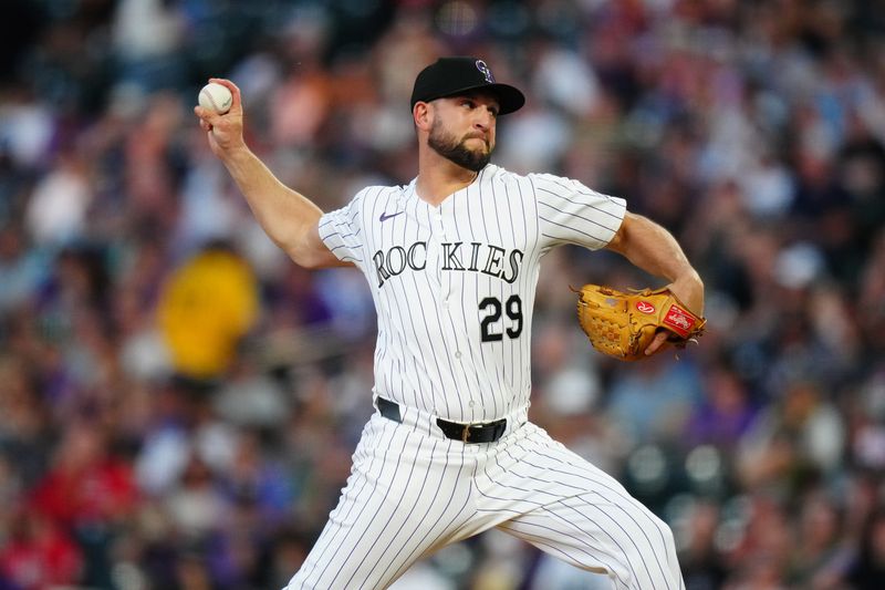 Jun 4, 2024; Denver, Colorado, USA; Colorado Rockies relief pitcher Matt Carasiti (29) delivers a pitch in the seventh inning against the Cincinnati Reds at Coors Field. Mandatory Credit: Ron Chenoy-USA TODAY Sports