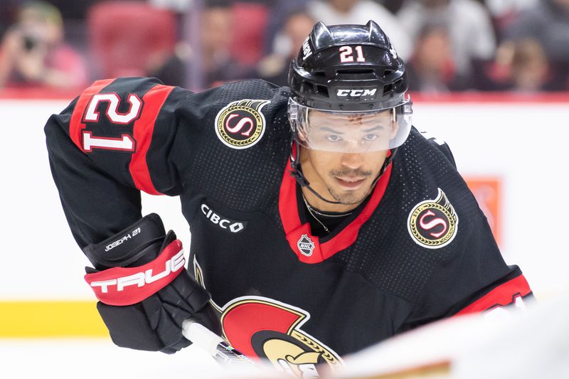 Feb 15, 2024; Ottawa, Ontario, CAN; Ottawa Senators right wing Mathieu Joseph (21) sets up for a face off in the first period  against the Anaheim Ducks at the Canadian Tire Centre. Mandatory Credit: Marc DesRosiers-USA TODAY Sports