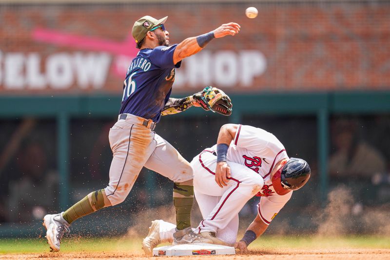 May 21, 2023; Cumberland, Georgia, USA; Seattle Mariners second baseman Jose Caballero (76) forces out Atlanta Braves third baseman Austin Riley (27) but can   t complete the double play during the eighth inning at Truist Park. Mandatory Credit: Dale Zanine-USA TODAY Sports