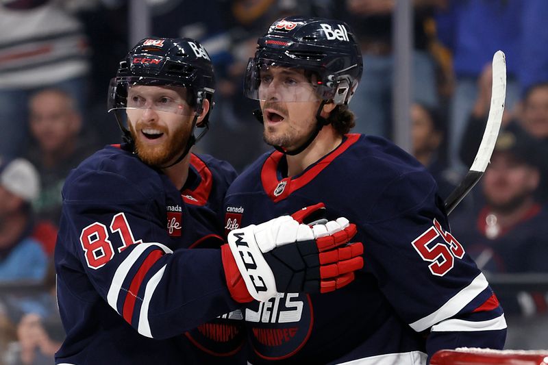 Oct 20, 2024; Winnipeg, Manitoba, CAN; Winnipeg Jets center Mark Scheifele (55) celebrates his second period goal with Winnipeg Jets left wing Kyle Connor (81) against the Pittsburgh Penguins at Canada Life Centre. Mandatory Credit: James Carey Lauder-Imagn Images