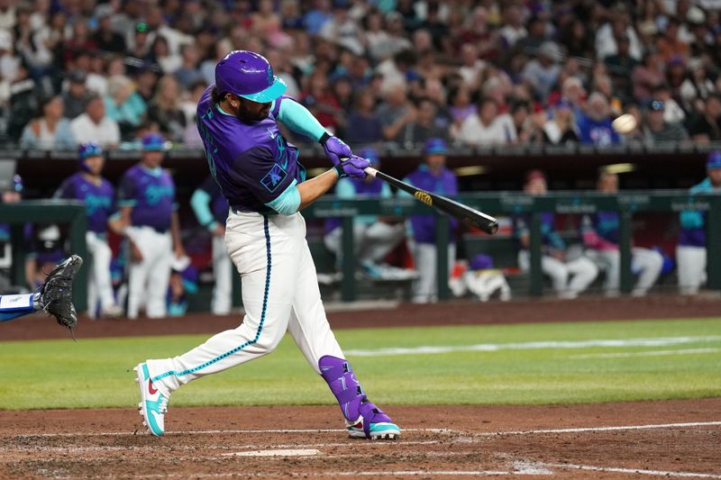 May 10, 2025; Phoenix, Arizona, USA; Arizona Diamondbacks third base Eugenio Suárez (28) hits a solo home run against the Los Angeles Dodgers during the sixth inning at Chase Field. Mandatory Credit: Joe Camporeale-Imagn Images